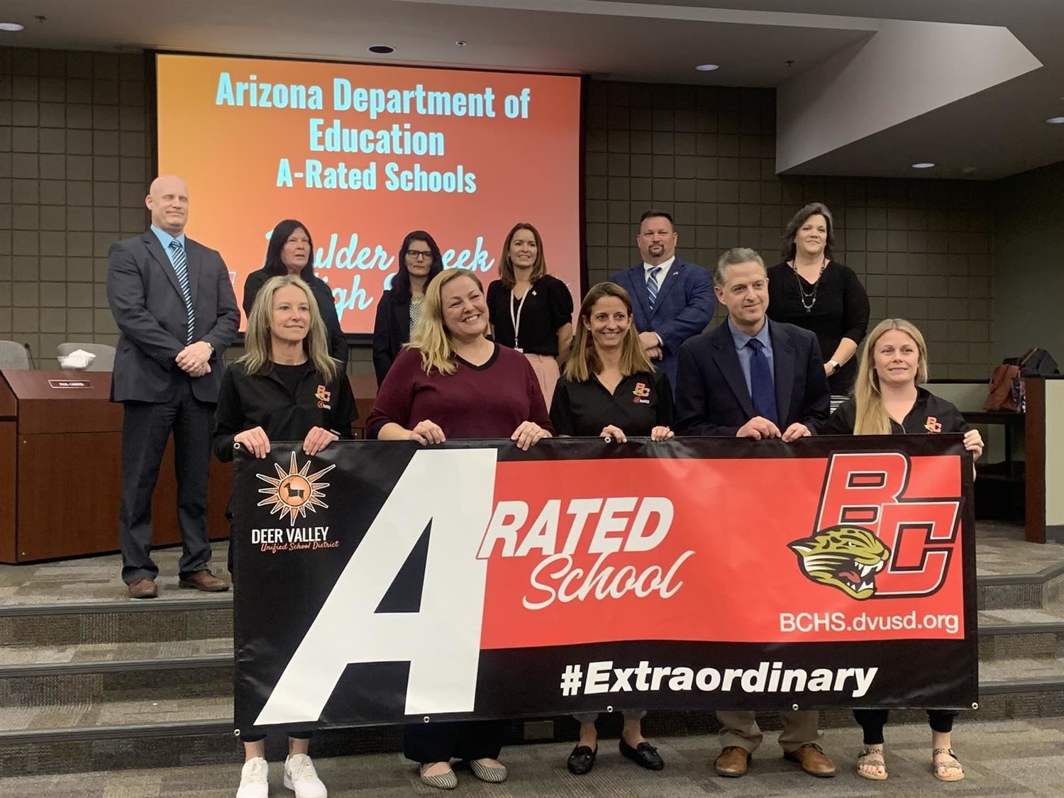  BCHS team with superintendent holding "A" rating Banner